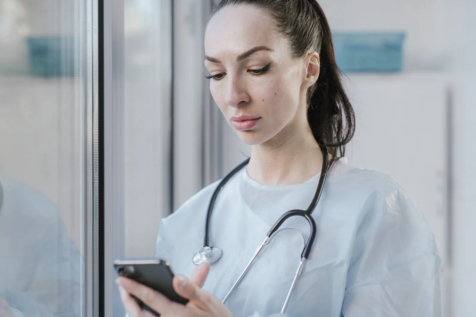 Clinician using AI-powered technology to support patient care in a modern hospital