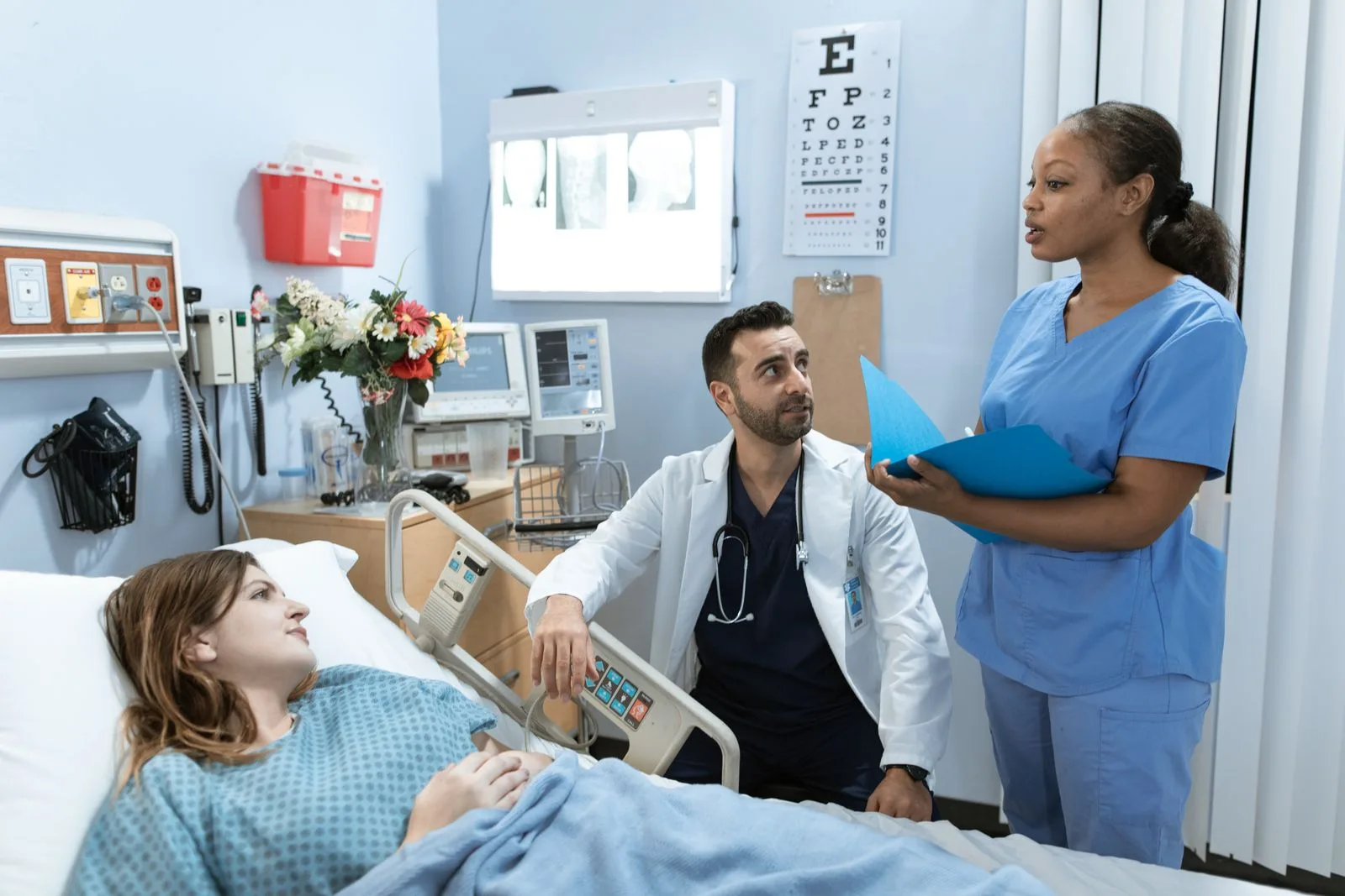 Healthcare team collaborating around patient data in a modern hospital