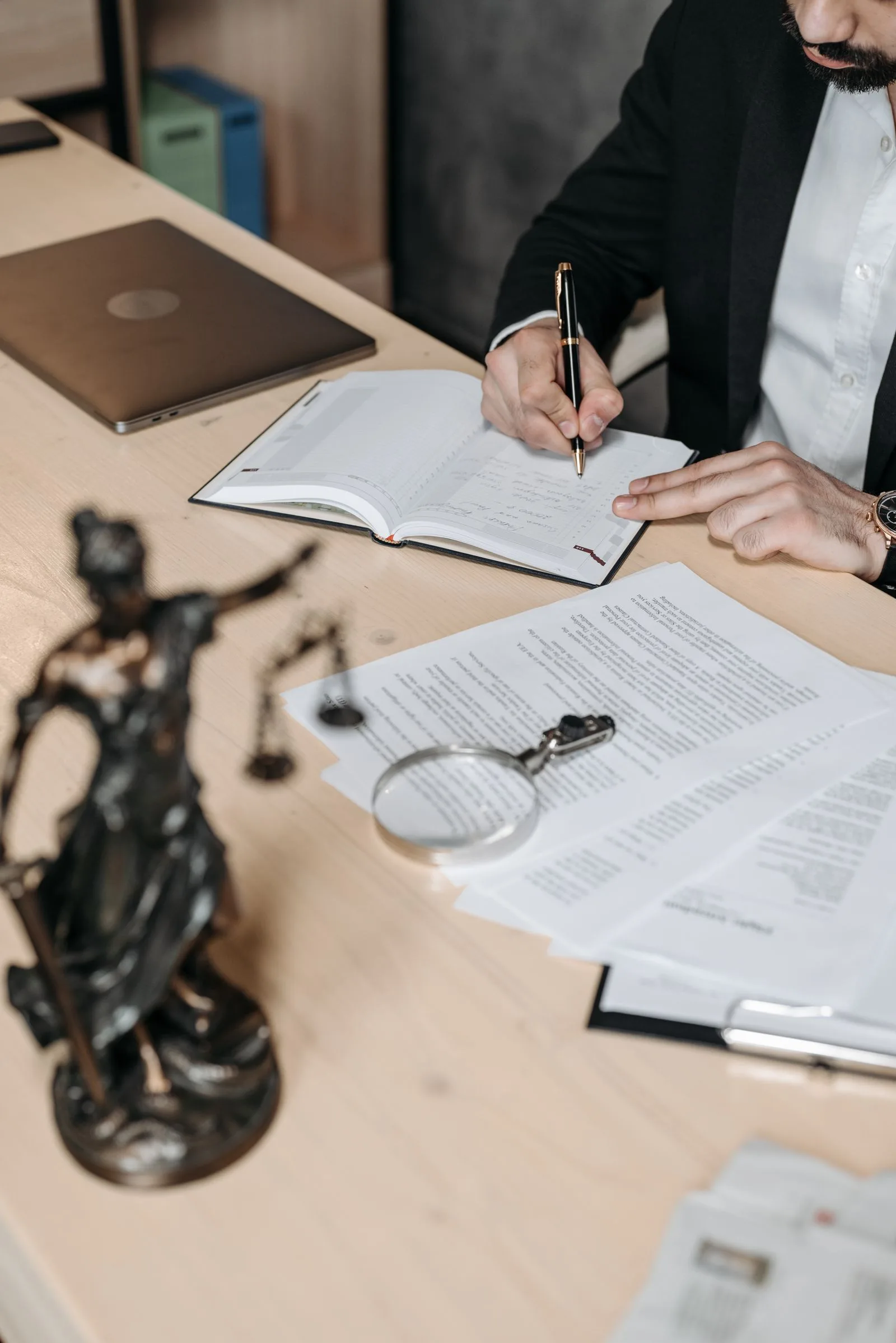 Legal professional reviewing contracts with AI-assisted technology in a law office