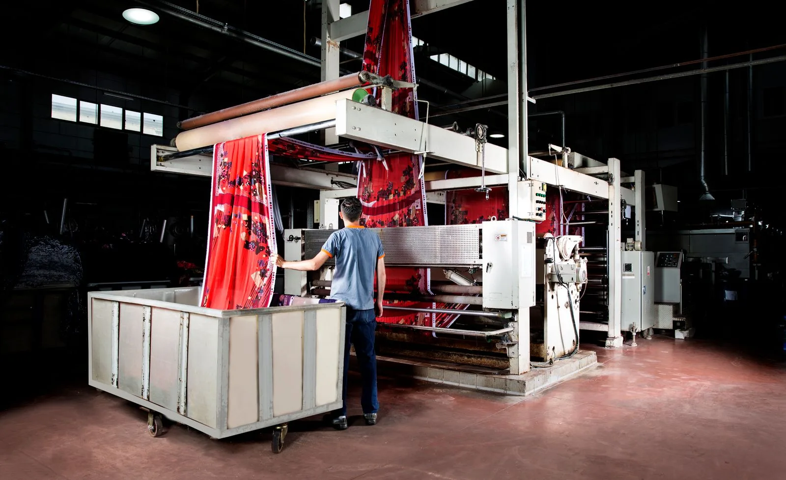 Workers and robotics on a modern factory production floor