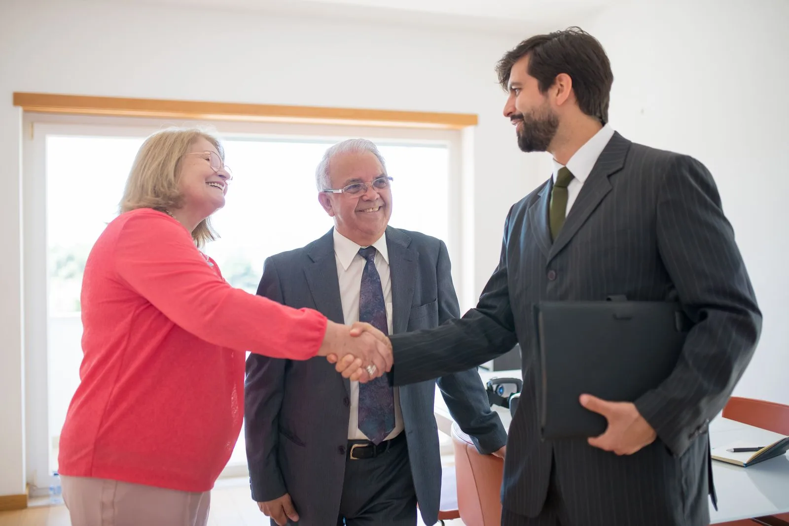 Real estate agent meeting clients to close a property deal