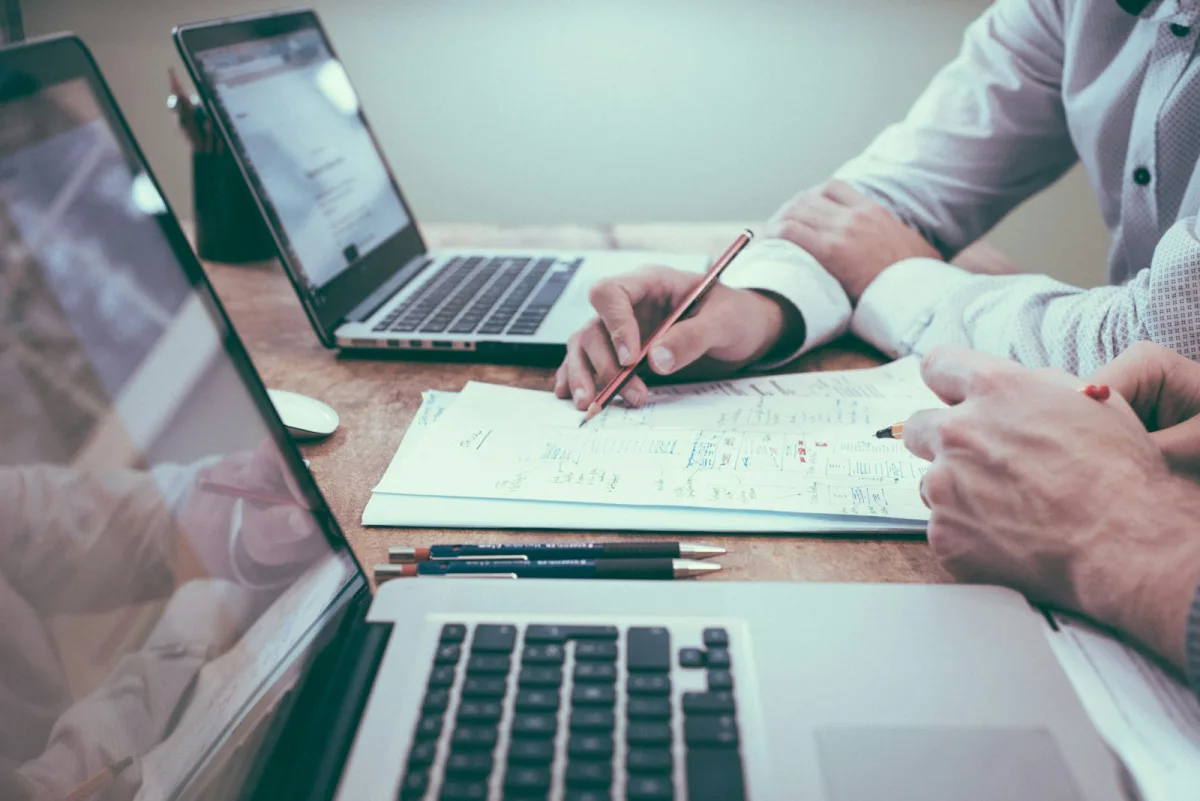 Finance professionals analysing reports and charts together